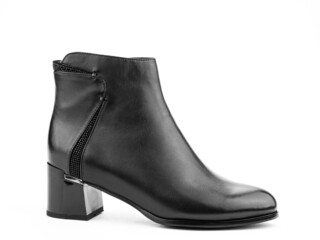 Women's autumn ankle black leather boots with black zip and average heels, isolated white background. Right side view. Fashion shoes.