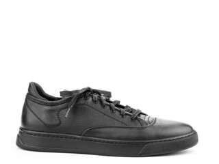 Black leather classic sneakers with laces. Casual men's style. Black rubber soles. Isolated close-up on white background. right side view.