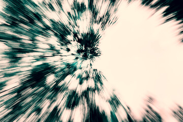 Zoom burst effect on tree foliage. Abstract and motion blur background. 