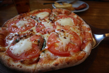 delicious Pizza Margherita on the wooden plate close-up
