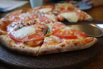 delicious Pizza Margherita on the wooden plate close-up