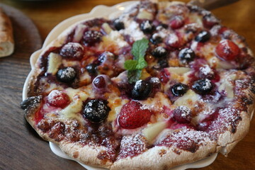 eating delicious and various Pizza on the wooden plate close-up