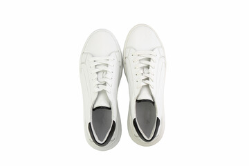 White leather sneakers. Casual women's style. White lacing and white rubber soles. Isolated close-up on white background. Top view. Fashion shoes