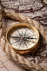 Golden old compass on the antique and vintage mundi map.