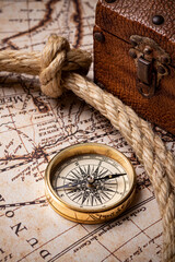 Fototapeta na wymiar Old golden compass on the antique and vintage mundi map. 