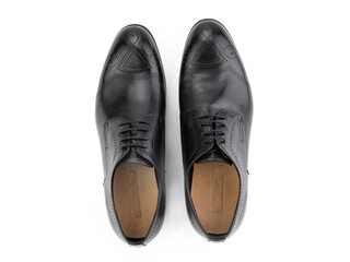 A pair of classic leather elegant men's shoes isolated white background. Groom's stylish black shoes. Isolated object close up on white background.