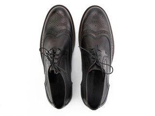 A pair of classic leather elegant men's shoes isolated white background. Groom's stylish black shoes. Isolated object close up on white background.