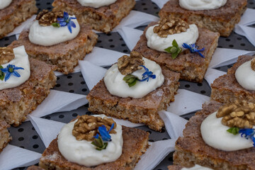 Tarts with whipped cream and walnuts.