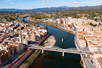 Aerial view of Catalan city of Tortosa on sunny spring day overlooking reconstructed Bridge of...
