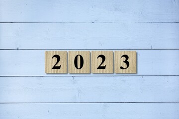 2023 on wooden block cube for new year change and start new business strategy concept.