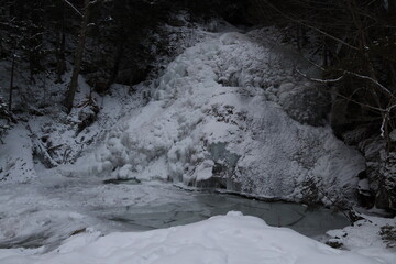 frozen winter waterfall covered in white snow © Marcy