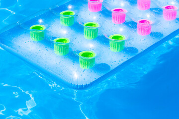 Multicolored inflatable pad floats in a swimming pool