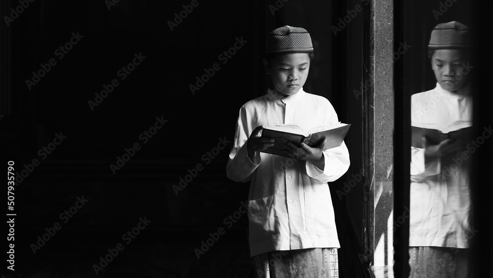 Wall mural muslim student standing in islamic mosque studying al quran book