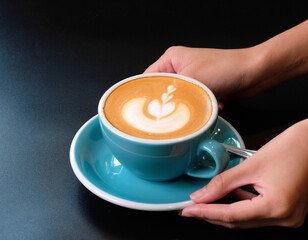 Waitress serving a cup of coffee with latte art to customer