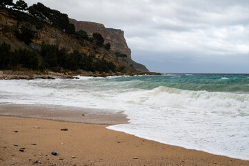 Stormy sea, high waves on yellow sandy beach in Cassis, Provence, France