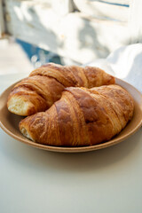 Summer morning in Provence, breakfast with fresh baked croissants and view on fisherman's boats in harbour of Cassis, Provence, France