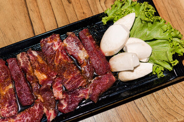 Premium frozen raw pork on plate, Korean traditional style fresh pork beef belly BBQ, Japanese meat hot pot or Shabu in the restaurant, barbecue food