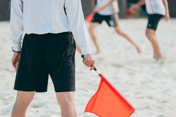 Beach volleyball game - closeup red flag