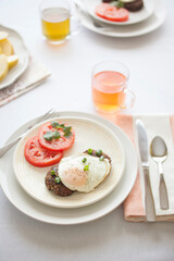 Breakfast for Two Mexican Style Black Bean Cakes with Fried Eggs and Sliced Tomatoes