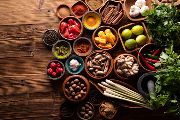 Thai food background. Ingredients in teak bowls on rustic wooden table.