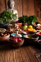 Thai food background. Ingredients in teak bowls on rustic wooden table.