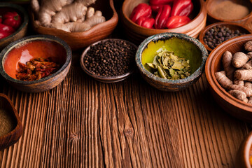 Obraz na płótnie Canvas Thai food background. Ingredients in teak bowls on rustic wooden table.