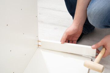 Assembly cabinet furniture. Do it youself concept. White chipboard interior