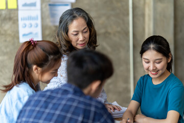 Diverse businesspeople negotiate at office meeting discussing startup project with clients, company managers have conversation with business partner, consider collaboration. Partnership concept