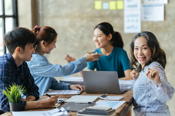ฺBusinesswoman leaders in office meeting room, Group of a young business people discussing business plan at modern startup office building.