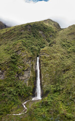 Aerial view of a waterfall in the Peruvian Andes. Fresh water source from high mountain.
