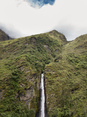 Aerial view of a waterfall in the Peruvian Andes. Fresh water source from high mountain.