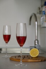 Champagne glasses with sparkling wine on kitchen desk