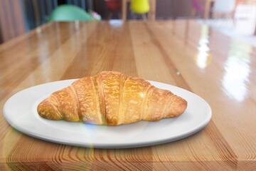 Tasty sweet breakfast croissant on the desk