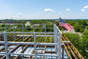 An American flag blows in the wind atop a building under construction in Rockville, Montgomery...