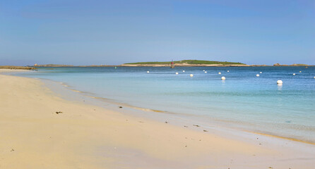 Fototapeta na wymiar view of a beach with fine white sand and clear blue water in Brittany - France