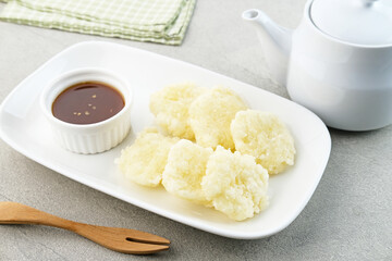 Cireng, a savory snack from West Java, Indonesia, made from tapioca flour and deep-fried, served with a spicy sauce.
