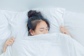 Fototapeta na wymiar girl sleeping on bright white mattress