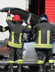 firefighters remove the top of the damaged car after the road index on the highway