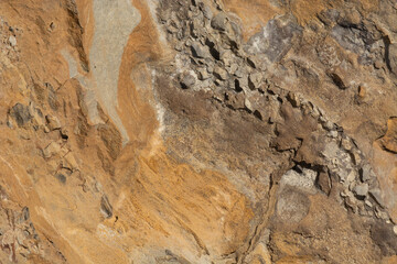 Closeup of yellowish textured Colorado rock with erosion from water and wind