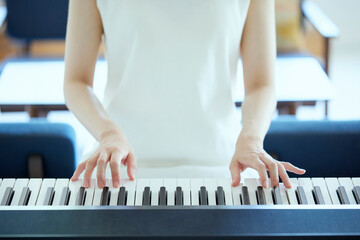 リビングでピアノを弾く日本人の女性