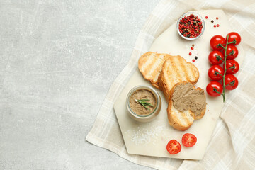 Tasty liver pate, bread and tomatoes on light grey table, top view. Space for text