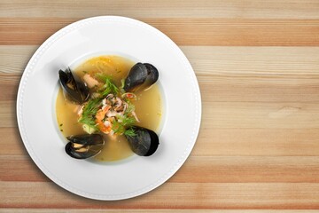 Traditional appetizer fish or chicken soup in plate.