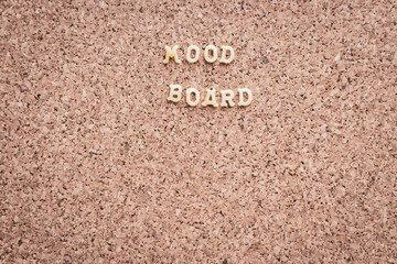 Fototapeta na wymiar Good mood text on cork background. Mood board background. Positive phrase. Letters on cork wallpaper. Positive slogan. Creative message. Lifestyle concept. Letters on board with copy space.