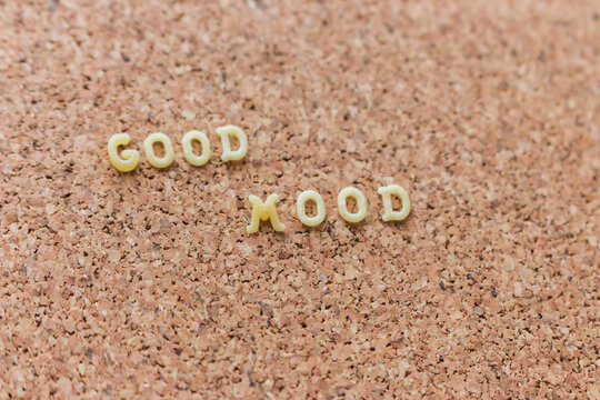 Good mood text on cork background. Mood board background. Positive phrase. Letters on cork wallpaper. Positive slogan. Creative message. Lifestyle concept. Letters on board with copy space.