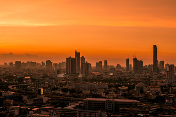 The high angle background of the city view with the secret light of the evening, blurring of night lights, showing the distribution of condominiums, dense homes in the capital community