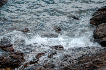 Sea waves breaking on rocky shore, natural background