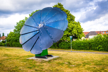 Rotating solar panel in flower shape in city park. Photovoltaic, alternative electricity source
