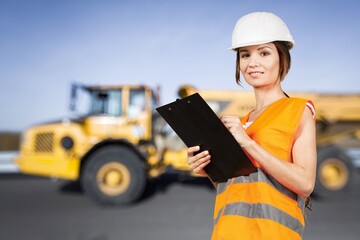 Female engineer in hard hat with tablet. Working on construction sites and buildings.