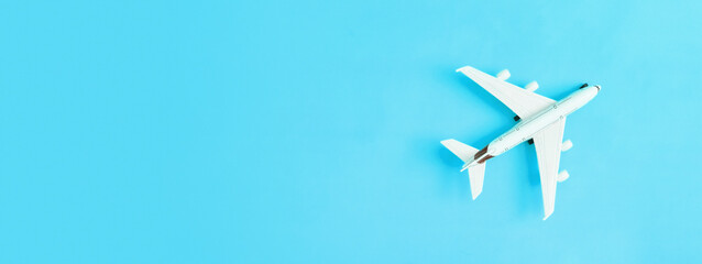 Banner with white airplane on blue background with copy space. Travel or trip concept