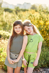 Fototapeta premium two cute girls on beautiful nature in summer